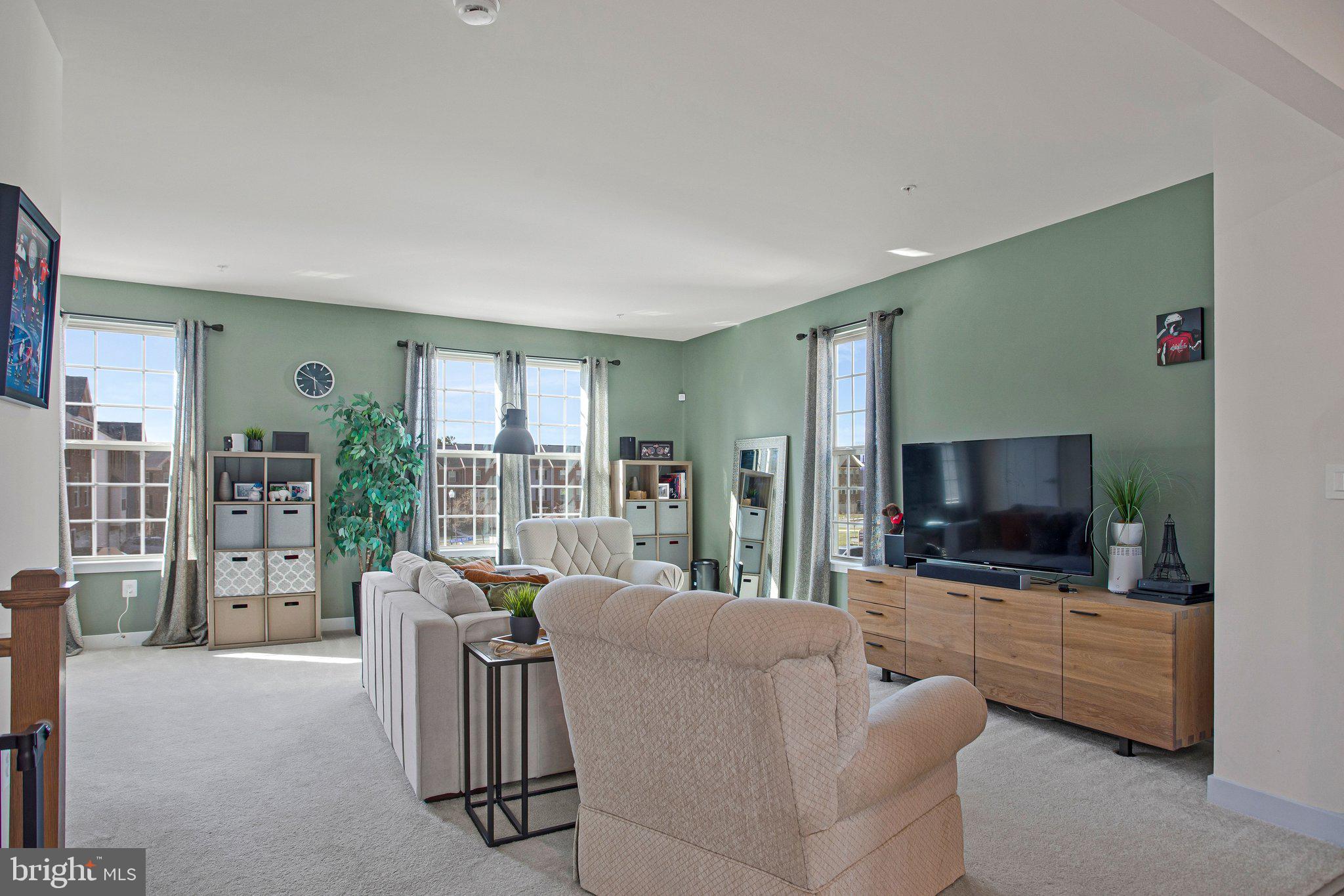 9012 Waller Tree Way Upper Marlboro, MD 20772 - Photo 10 of 29 a living room with furniture a flat screen tv and a floor to ceiling window
