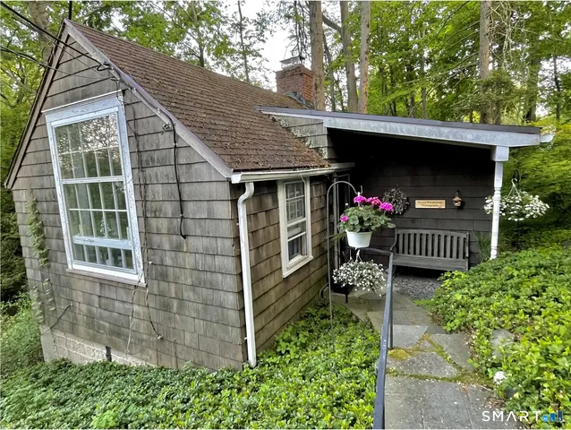 a front view of house with deck and entertaining space