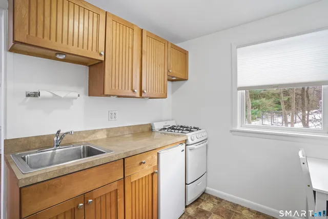 a kitchen with a sink cabinets and window