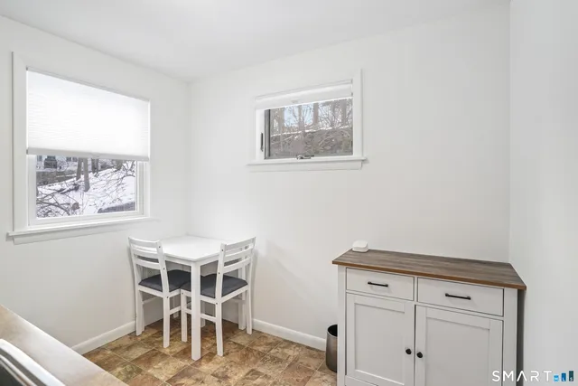 a room with wooden floor and windows