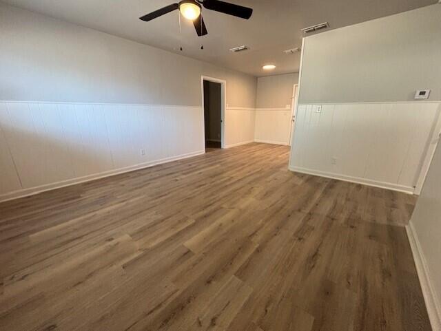 4410 43rd Street Lubbock, TX 79414 - Photo 2 of 9 an empty room with wooden floor and windows