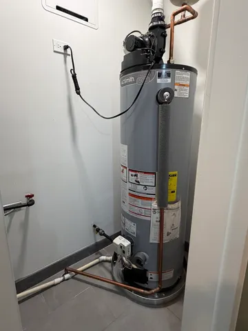 a room with water heater and wooden floor