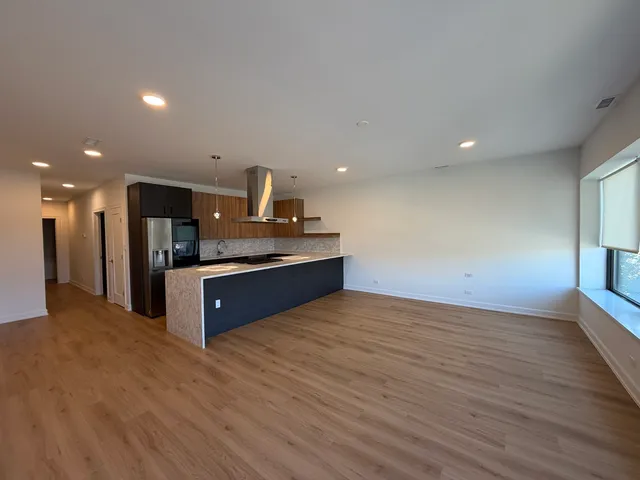 a kitchen with stainless steel appliances a sink and a large counter top