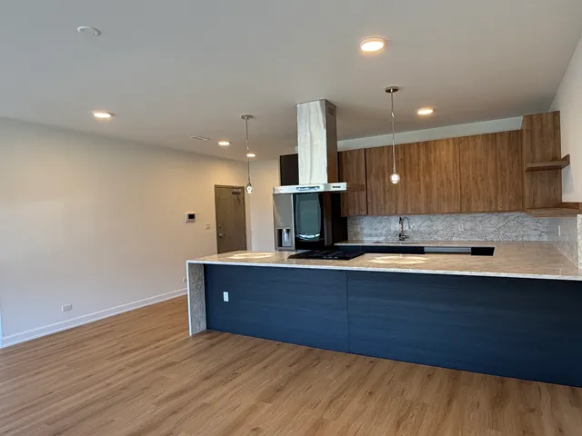 a large kitchen with a sink and a stove top oven