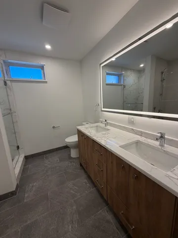 a bathroom with a double vanity sink and a mirror
