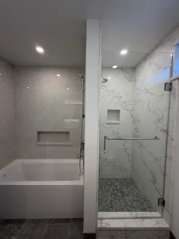 a bathroom with a bathtub and a shower