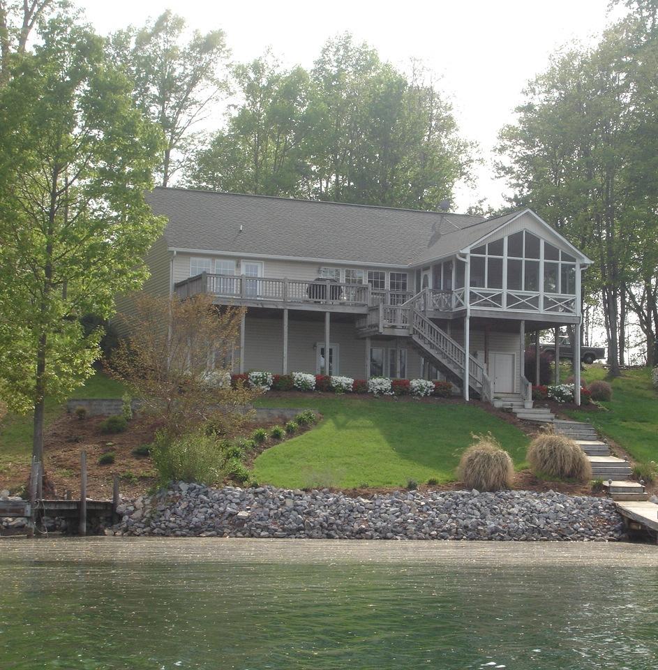 842 Cove Road Penhook, VA 24137 - Photo 1 of 22 a front view of a house with a garden