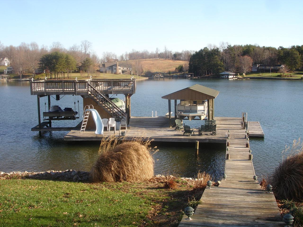 842 Cove Road Penhook, VA 24137 - Photo 19 of 22 a view of a lake with boats and trees in the background