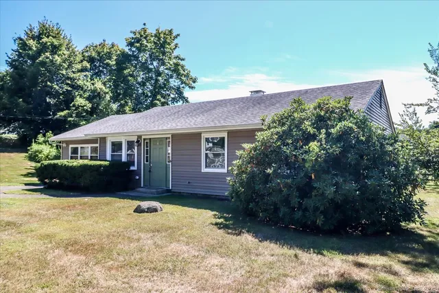 a front view of a house with a yard