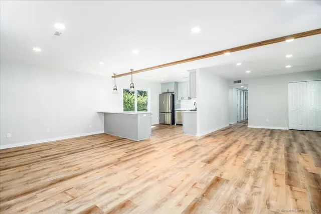 a view of an empty room and wooden floor