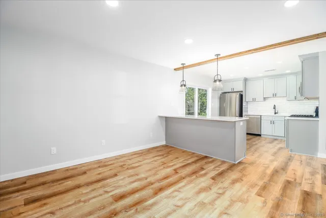 a view of a kitchen with wooden floor