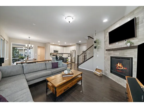 a bedroom with a bed next to a window with kitchen view