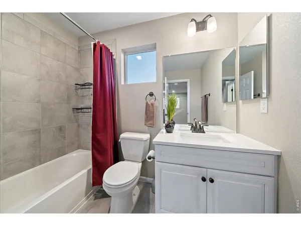 a bathroom with a double vanity sink mirror and shower