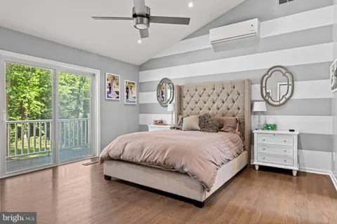 a bedroom with a bed chandelier and a window