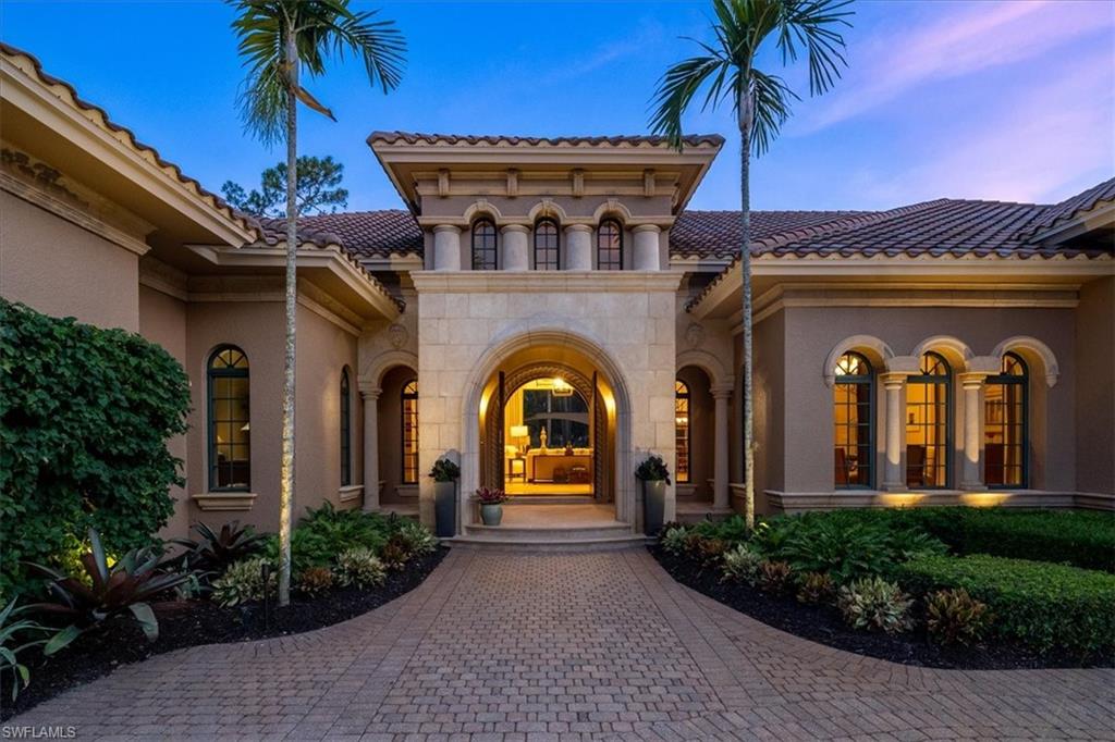 16012 Trebbio Way Naples, FL 34110 - Photo 1 of 1 a front view of a house with a garden