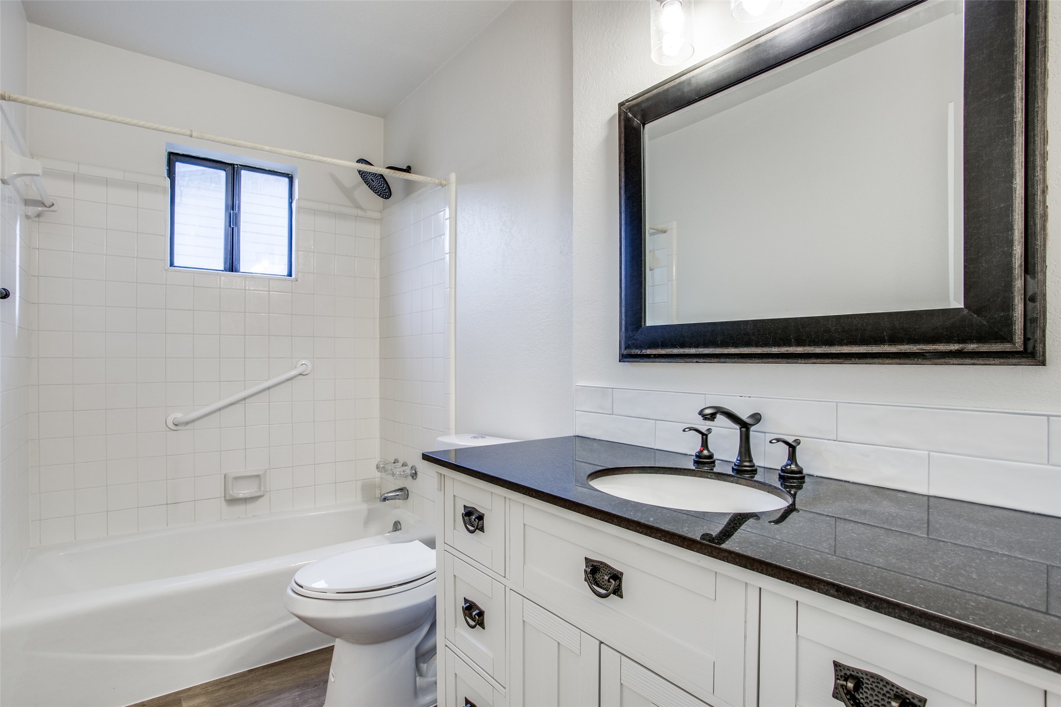 2212 Rifle Bend Drive Georgetown, TX 78626 - Photo 11 of 15 a bathroom with a toilet a sink a mirror and bathtub