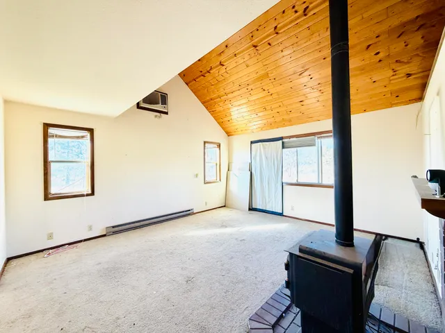 a view of a dining room with furniture and window