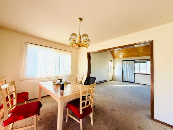 a view of a dining room with furniture and window