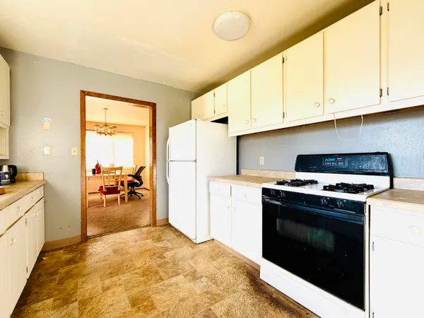 a kitchen with a stove and a refrigerator