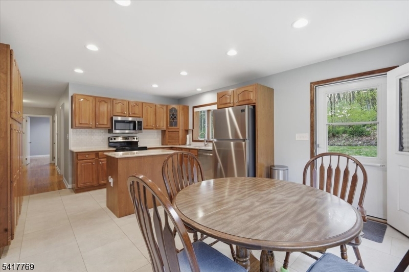 9 Henderson Hill Road Hampton, NJ 08827 - Photo 13 of 36 a kitchen with stainless steel appliances granite countertop a refrigerator a stove a sink a dining table and chairs