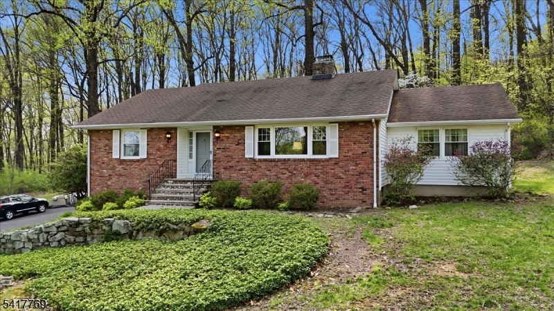 9 Henderson Hill Road Hampton, NJ 08827 - Photo 27 of 36 a view of a brick house with a yard plants and large tree