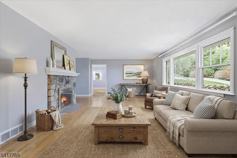 9 Henderson Hill Road Hampton, NJ 08827 - Photo 3 of 36 a living room with furniture a fireplace and a large window