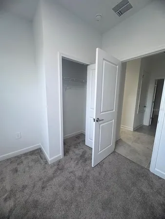 a view of an empty room and a window