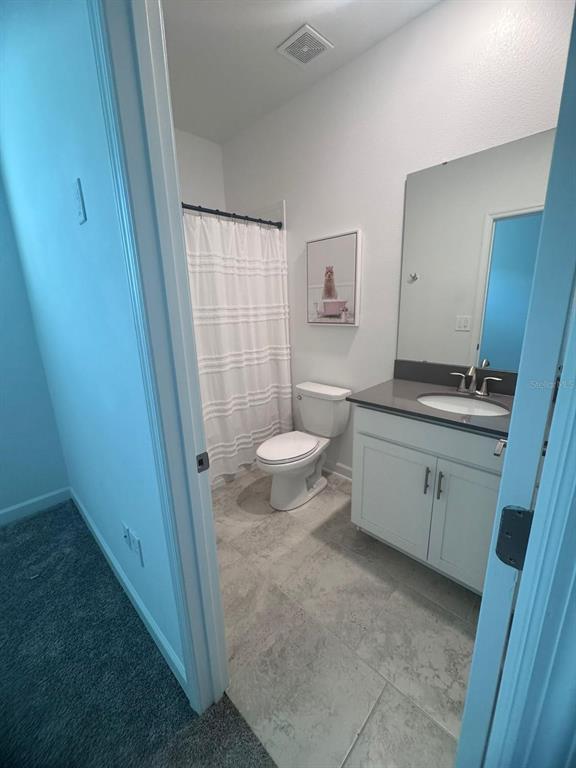 3071 Camden Way Davenport, FL 33837 - Photo 17 of 44 a bathroom with a sink toilet and shower