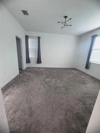 a spacious bathroom with a granite countertop sink a toilet a mirror and vanity