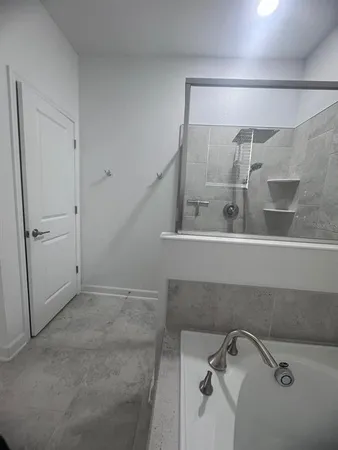a large white kitchen with a sink and cabinets