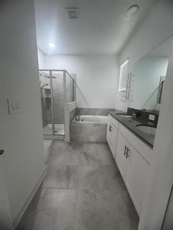 a large kitchen with stainless steel appliances kitchen island granite countertop a refrigerator a stove a sink and a stove