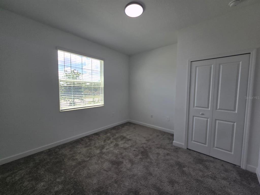 3071 Camden Way Davenport, FL 33837 - Photo 27 of 44 an empty room with windows