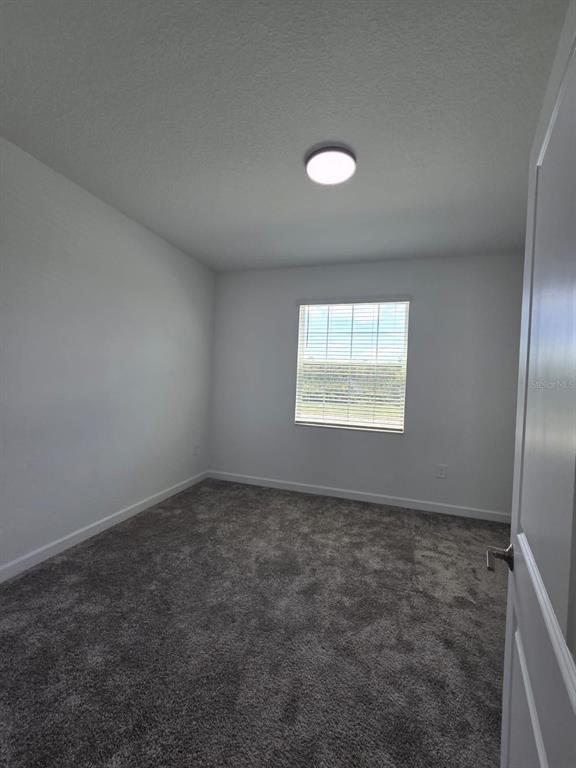 3071 Camden Way Davenport, FL 33837 - Photo 28 of 44 an empty room with windows