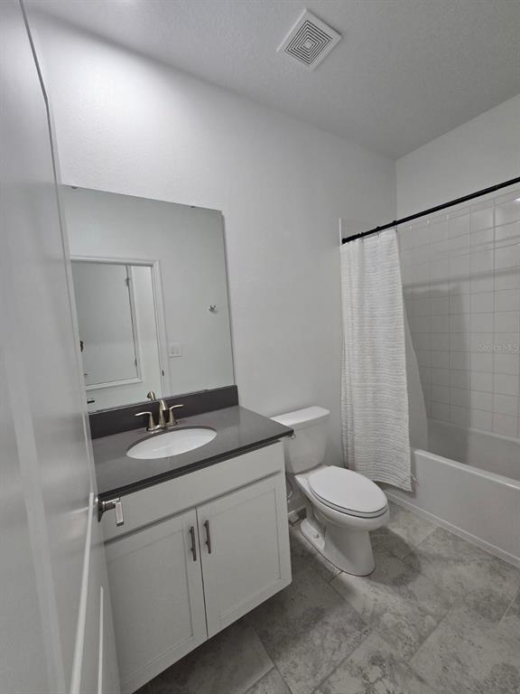 3071 Camden Way Davenport, FL 33837 - Photo 29 of 44 a bathroom with a granite countertop sink toilet and shower