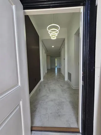 a view of a hallway with a refrigerator
