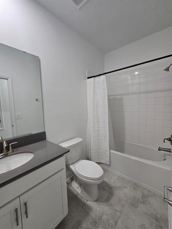 3071 Camden Way Davenport, FL 33837 - Photo 31 of 44 a bathroom with a granite countertop sink toilet a mirror and shower