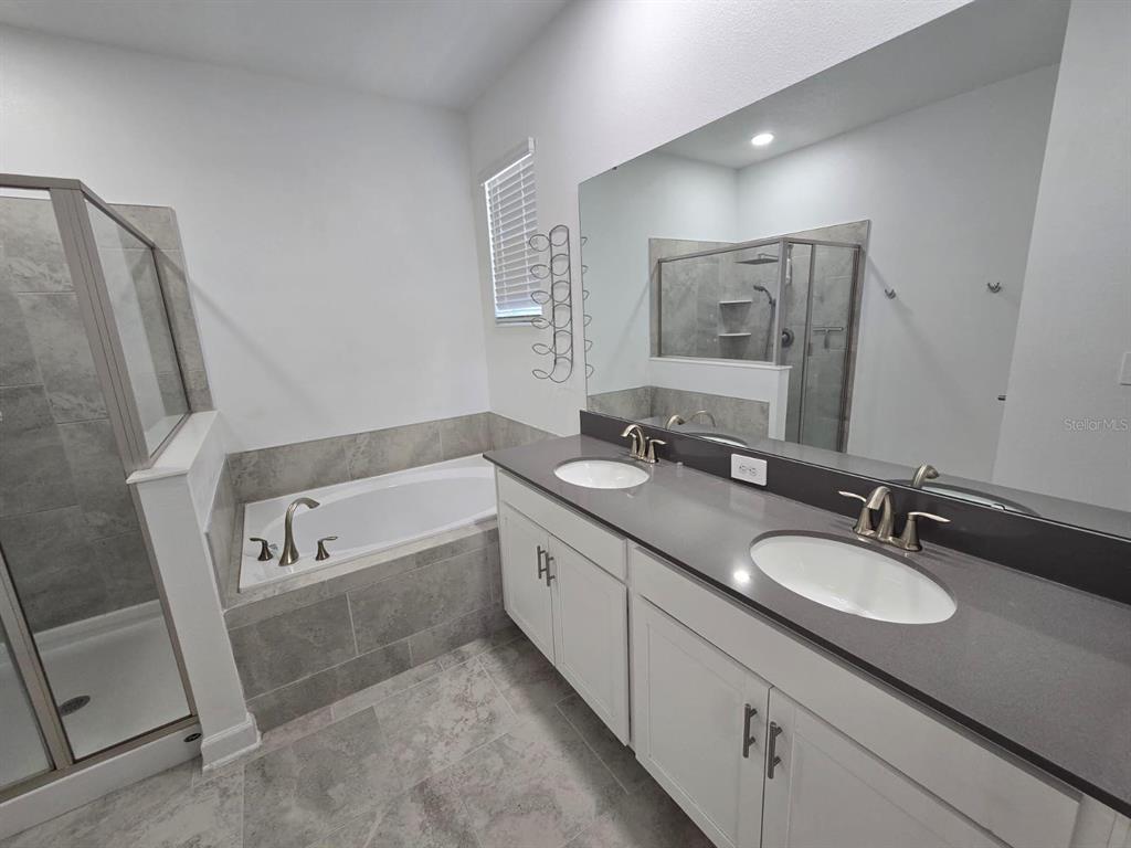 3071 Camden Way Davenport, FL 33837 - Photo 43 of 44 a bathroom with a granite countertop sink and a mirror