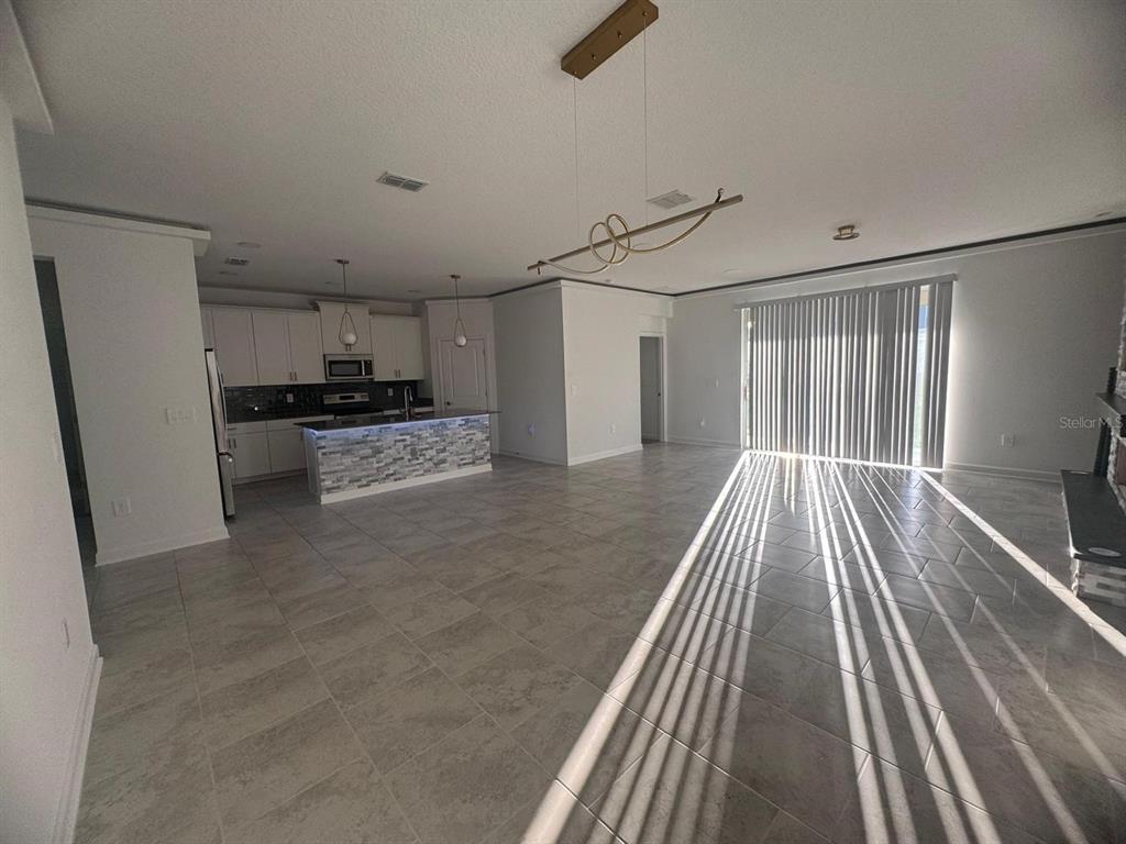 3071 Camden Way Davenport, FL 33837 - Photo 8 of 44 a view of a kitchen with wooden floor electronic appliances and furniture