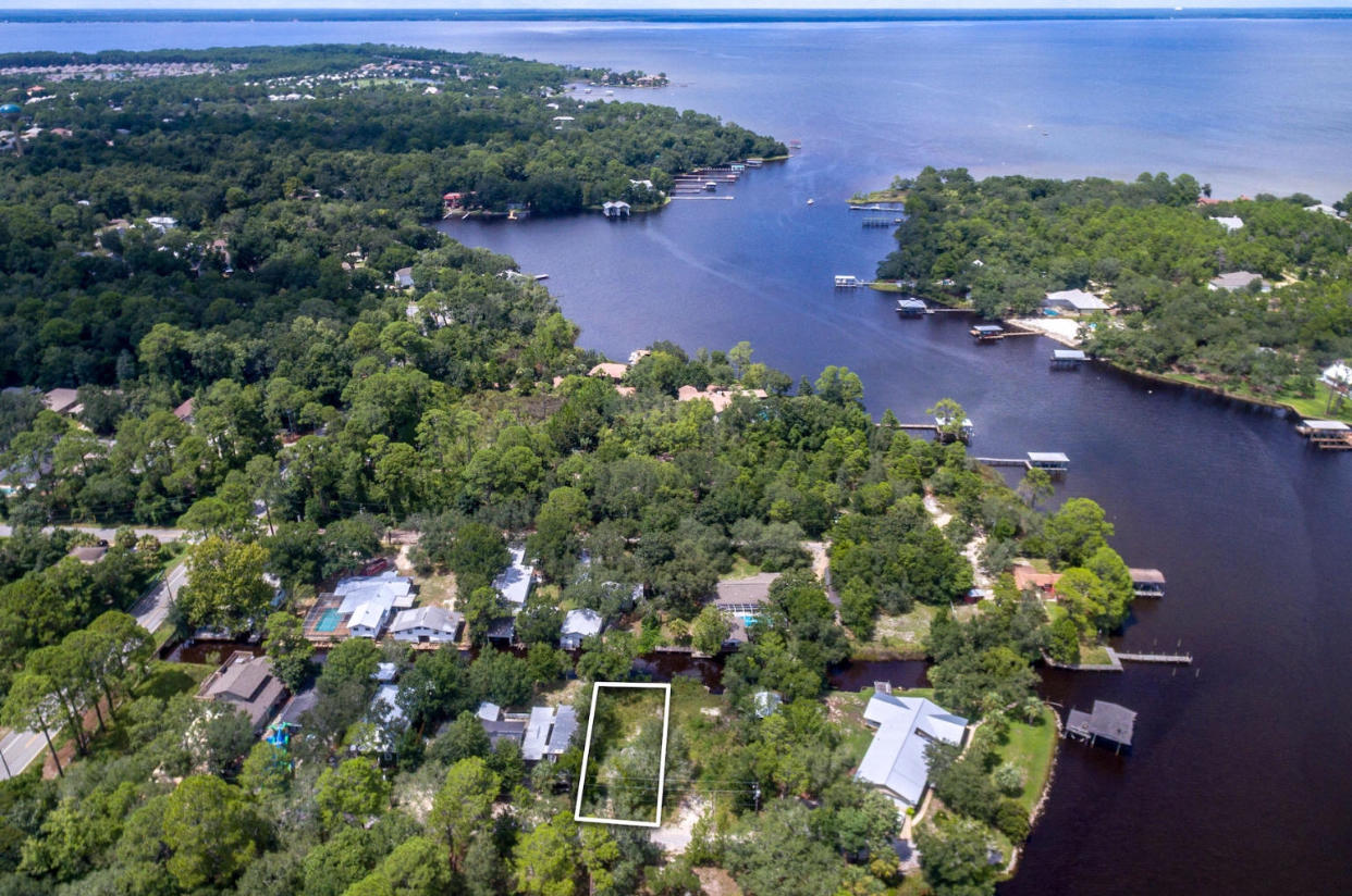 63 Bayou Road Santa Rosa Beach, FL 32459 - Photo 1 of 10 an aerial view of a house with a yard