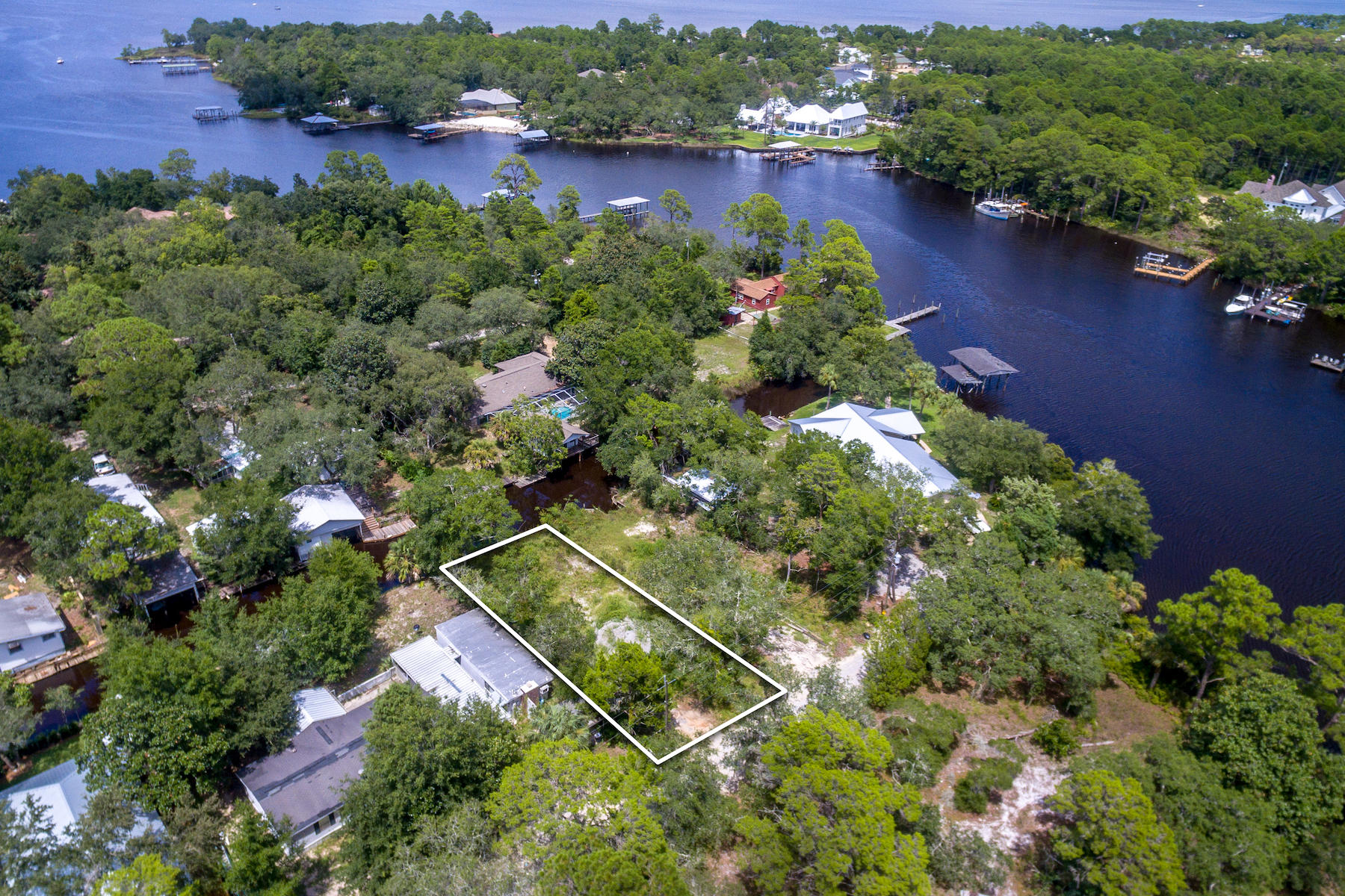 63 Bayou Road Santa Rosa Beach, FL 32459 - Photo 6 of 10 an aerial view of a house with a yard and lake view