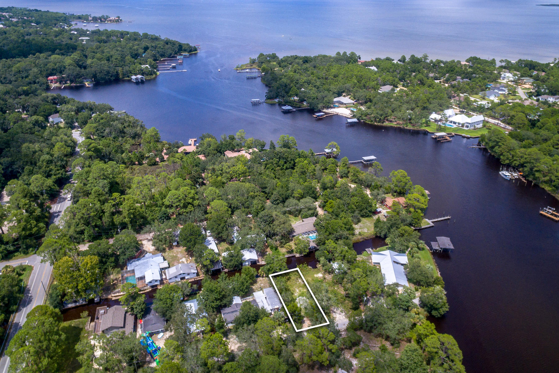 63 Bayou Road Santa Rosa Beach, FL 32459 - Photo 7 of 10 an aerial view of a house with a yard and lake view