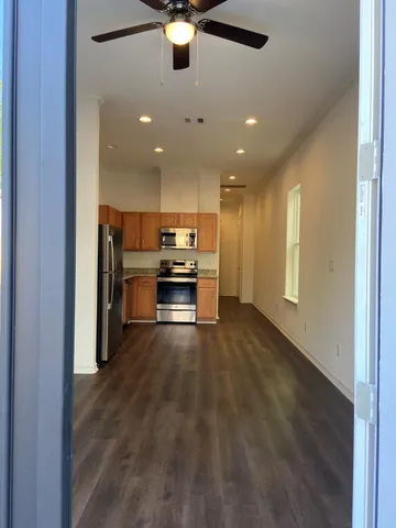 a view of kitchen with refrigerator and microwave