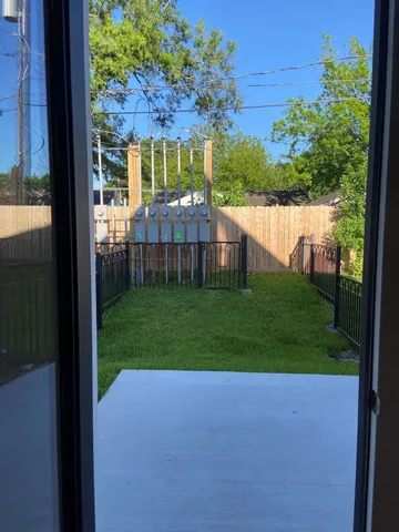 a view of a house with backyard and porch