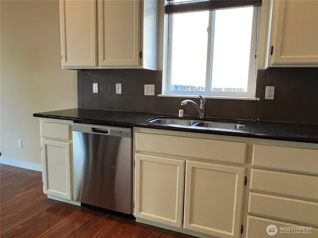a kitchen with appliances cabinets and a window