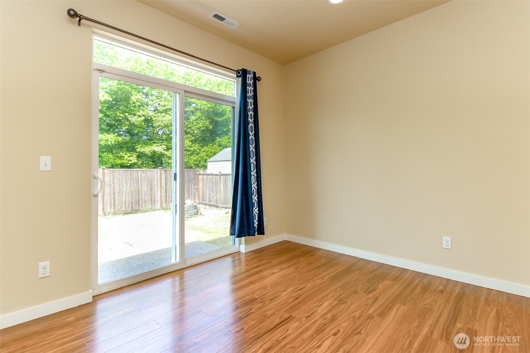 1605 Riddell Avenue Northeast Orting, WA 98360 - Photo 13 of 35 a view of an empty room with wooden floor and a window