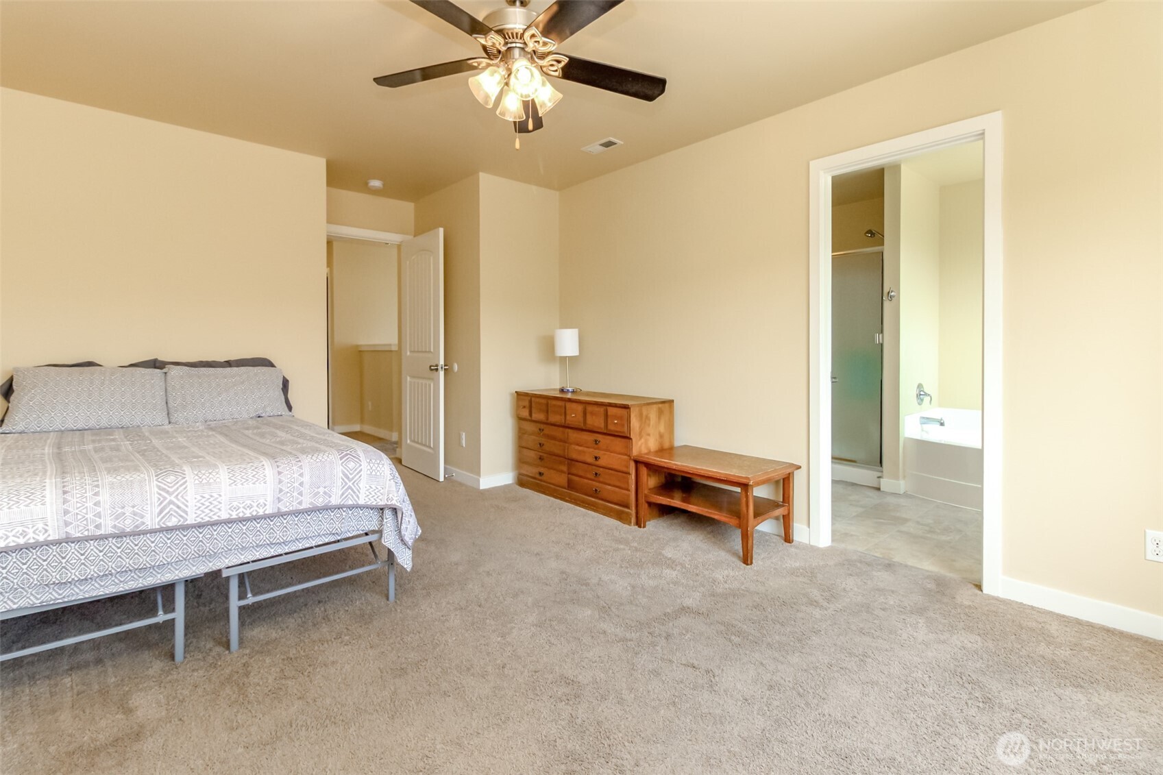1605 Riddell Avenue Northeast Orting, WA 98360 - Photo 18 of 35 a bedroom with a bed and a chandelier