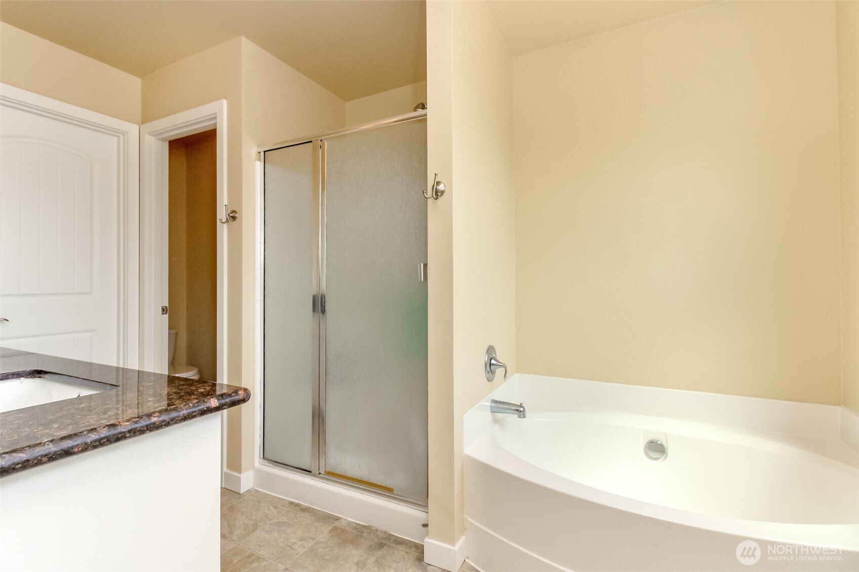 1605 Riddell Avenue Northeast Orting, WA 98360 - Photo 22 of 35 a bathroom with a granite countertop sink and a bathtub