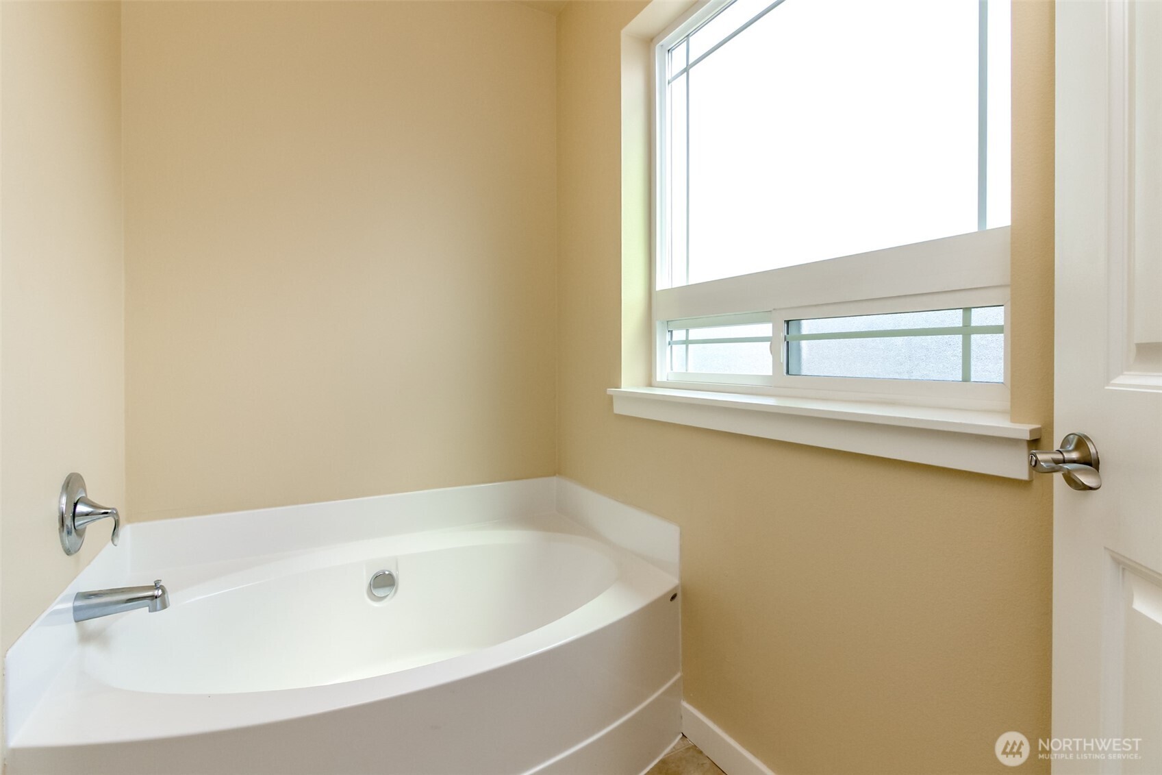 1605 Riddell Avenue Northeast Orting, WA 98360 - Photo 23 of 35 a white bath tub sitting next to a window