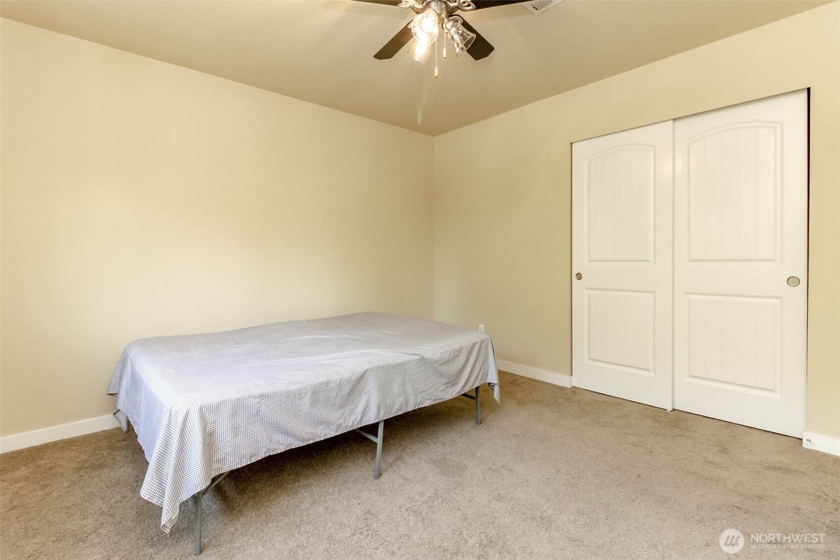 1605 Riddell Avenue Northeast Orting, WA 98360 - Photo 27 of 35 a bed sitting in a room next to a window