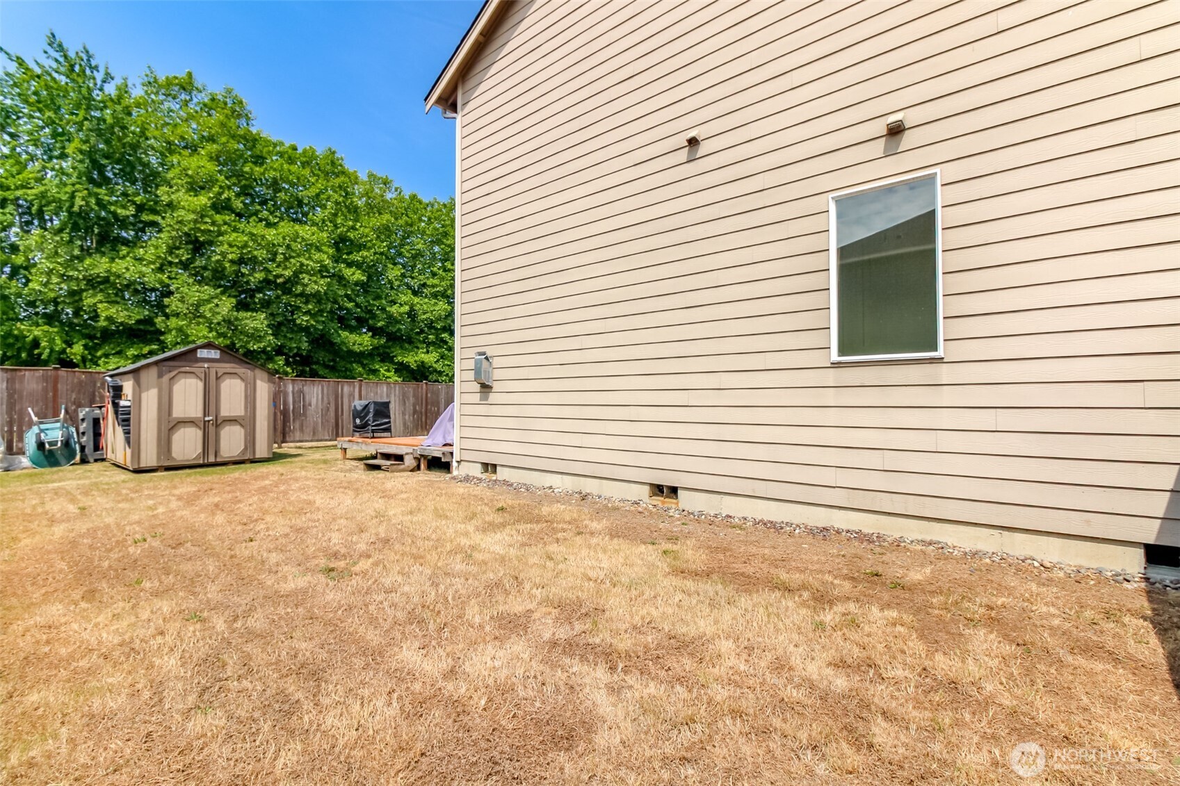 1605 Riddell Avenue Northeast Orting, WA 98360 - Photo 32 of 35 a view of a house with a yard and garage